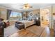 Spacious bedroom features a large window, wooden accent wall, and ensuite bathroom access at 648 Sunrise Lake Pl, Henderson, NV 89002