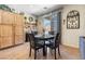 Cozy dining area featuring a round table, four chairs, and a sliding glass door to the exterior at 648 Sunrise Lake Pl, Henderson, NV 89002