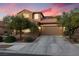 Charming two-story home featuring a well-maintained front yard, concrete driveway, and a cozy, traditional aesthetic at 648 Sunrise Lake Pl, Henderson, NV 89002