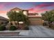 Charming two-story home featuring a well-maintained front yard, concrete driveway, and a cozy, traditional aesthetic at 648 Sunrise Lake Pl, Henderson, NV 89002