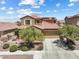 Charming two-story home featuring a well-maintained front yard and a spacious two-car garage at 648 Sunrise Lake Pl, Henderson, NV 89002