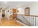 Upstairs hallway with wood floors and a decorative railing at 648 Sunrise Lake Pl, Henderson, NV 89002