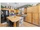Well-lit kitchen with granite counters, wood cabinets, and stainless steel appliances at 648 Sunrise Lake Pl, Henderson, NV 89002