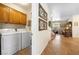 Bright laundry room with a washer, dryer, cabinets, and storage solutions at 648 Sunrise Lake Pl, Henderson, NV 89002