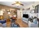 Living room with wood accent wall, cozy seating, and laminate wood floor at 648 Sunrise Lake Pl, Henderson, NV 89002