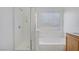 Clean bathroom featuring a glass shower, soaking tub, and bright window at 6480 Chebec St, North Las Vegas, NV 89084