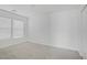 Bedroom with neutral carpet and two windows at 6480 Chebec St, North Las Vegas, NV 89084