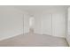 Carpeted bedroom boasts neutral walls, ample closet space, and plenty of natural light at 6480 Chebec St, North Las Vegas, NV 89084