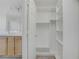 Walk-in closet featuring custom shelving, bright lighting, and ample storage at 6480 Chebec St, North Las Vegas, NV 89084