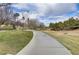 Serene walking path alongside a lush greenbelt, providing a tranquil escape into nature at 6480 Chebec St, North Las Vegas, NV 89084