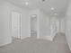 Bright hallway features neutral walls and carpeting, with an open staircase and access to other rooms at 6480 Chebec St, North Las Vegas, NV 89084