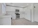 Well-lit kitchen features white cabinets and stainless steel appliances at 6480 Chebec St, North Las Vegas, NV 89084