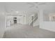 Open-concept living room with adjacent kitchen and staircase at 6480 Chebec St, North Las Vegas, NV 89084