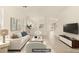 Bright living room features neutral furniture and a modern open-concept design at 6480 Chebec St, North Las Vegas, NV 89084