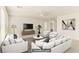 Open living room features stylish furniture, ceiling fan, and neutral decor at 6480 Chebec St, North Las Vegas, NV 89084
