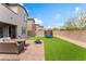 Outdoor patio with furniture, a fire pit, a small trampoline, and an artificial grass area at 7132 Sayonara Vista St, North Las Vegas, NV 89084