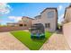 Expansive backyard with artificial turf, a trampoline, and desert landscaping, perfect for outdoor activities at 7132 Sayonara Vista St, North Las Vegas, NV 89084