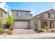 Charming two-story home with a stone-accented facade and brick driveway at 7132 Sayonara Vista St, North Las Vegas, NV 89084