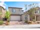 Charming two-story home with a stone-accented facade and brick driveway at 7132 Sayonara Vista St, North Las Vegas, NV 89084