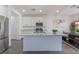 Kitchen features granite countertops, stainless appliances, and a center island with seating at 7132 Sayonara Vista St, North Las Vegas, NV 89084