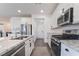 Well-equipped kitchen has stainless appliances, granite counters and white cabinetry at 7132 Sayonara Vista St, North Las Vegas, NV 89084