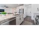 Modern kitchen features granite counters, stainless appliances, and eat-in island at 7132 Sayonara Vista St, North Las Vegas, NV 89084