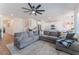 Open-concept living area has an expansive sectional couch and flows into the eat-in kitchen at 7132 Sayonara Vista St, North Las Vegas, NV 89084