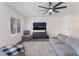 Cozy living room with a large sectional couch, television, and a bright window at 7132 Sayonara Vista St, North Las Vegas, NV 89084
