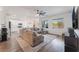 Open-concept living area showcases a large sectional couch and an adjacent eat-in kitchen at 7132 Sayonara Vista St, North Las Vegas, NV 89084