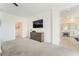 Spacious main bedroom features plush carpet, ceiling fan, mounted television, and attached bath at 7132 Sayonara Vista St, North Las Vegas, NV 89084
