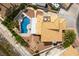 Aerial view showcasing a serene backyard with a pool, complemented by lush greenery and a stone-paved lounging area at 730 Rusty Spur Dr, Henderson, NV 89014