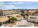 Aerial view showcasing a well-maintained residential neighborhood with charming houses, lush landscaping, and community streets at 730 Rusty Spur Dr, Henderson, NV 89014