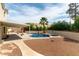 Spacious backyard features a refreshing pool, a covered patio, and a mix of gravel and concrete pathways at 730 Rusty Spur Dr, Henderson, NV 89014
