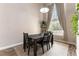Cozy dining room featuring dark wood table and chairs, light gray walls, and a window with natural light at 730 Rusty Spur Dr, Henderson, NV 89014