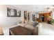 Inviting living space with tile flooring, a comfortable sofa, a coffee table, and seamless flow into the kitchen at 730 Rusty Spur Dr, Henderson, NV 89014