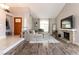 Bright living room featuring a cozy fireplace, plush sectional, and contemporary decor at 730 Rusty Spur Dr, Henderson, NV 89014