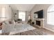 Bright living room featuring a cozy fireplace, plush sectional, and contemporary decor at 730 Rusty Spur Dr, Henderson, NV 89014