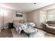 Relaxing main bedroom with a floral comforter, wood-look floors, and bay window seating for reading at 730 Rusty Spur Dr, Henderson, NV 89014