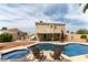 Inviting backyard pool features a relaxing spa, poolside seating, and covered patio at 730 Rusty Spur Dr, Henderson, NV 89014