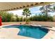 Inviting pool with a tropical palm tree and lush landscaping, perfect for relaxing and entertaining outdoors at 730 Rusty Spur Dr, Henderson, NV 89014