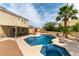 Beautiful backyard pool and spa combination, framed by a lush green lawn, and a cozy patio at 730 Rusty Spur Dr, Henderson, NV 89014