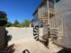 Exterior shot of a home's backyard with a spiral staircase, blue sky, and block wall at 7564 Durham Hall Ave # 201, Las Vegas, NV 89130
