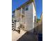 Exterior shot of a home's backyard with a spiral staircase and neutral stucco at 7564 Durham Hall Ave # 201, Las Vegas, NV 89130