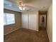 This bedroom features neutral walls, carpet, a ceiling fan, closet and an entrance to a hallway at 7564 Durham Hall Ave # 201, Las Vegas, NV 89130