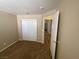 This bedroom features neutral walls, carpet, a closet and an entrance to a hallway at 7564 Durham Hall Ave # 201, Las Vegas, NV 89130