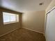 This bedroom features neutral walls, carpet and a window and closet at 7564 Durham Hall Ave # 201, Las Vegas, NV 89130