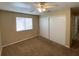 This bedroom features neutral walls, carpet, a ceiling fan and a closet at 7564 Durham Hall Ave # 201, Las Vegas, NV 89130