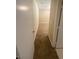 Hallway leading to carpeted room, side view from the dining area of the home at 7564 Durham Hall Ave # 201, Las Vegas, NV 89130