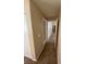 This hallway leads to other rooms in the home and has neutral walls and flooring at 7564 Durham Hall Ave # 201, Las Vegas, NV 89130