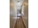 Bright hallway with wood-look flooring and neutral walls at 7564 Durham Hall Ave # 201, Las Vegas, NV 89130